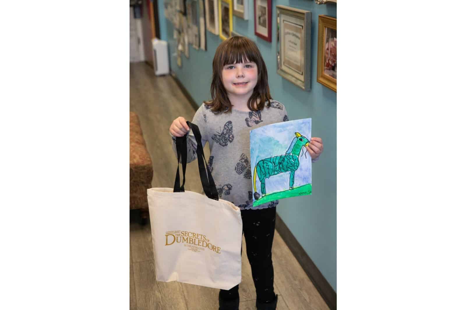 A student showing her artwork