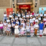 Kids showing their art certificates