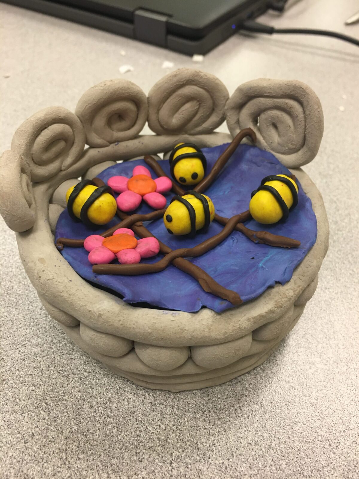 Bees and two flowers made from clay