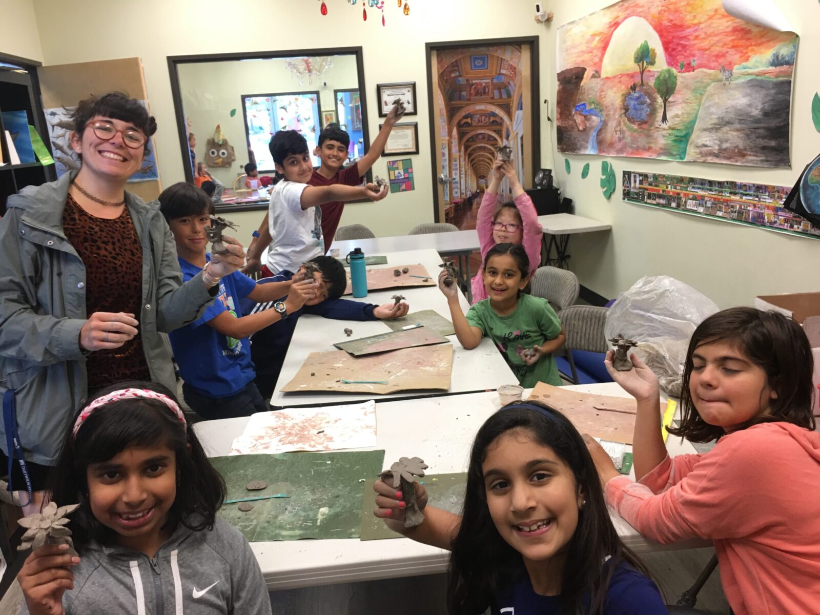 Students showing their clay crafts