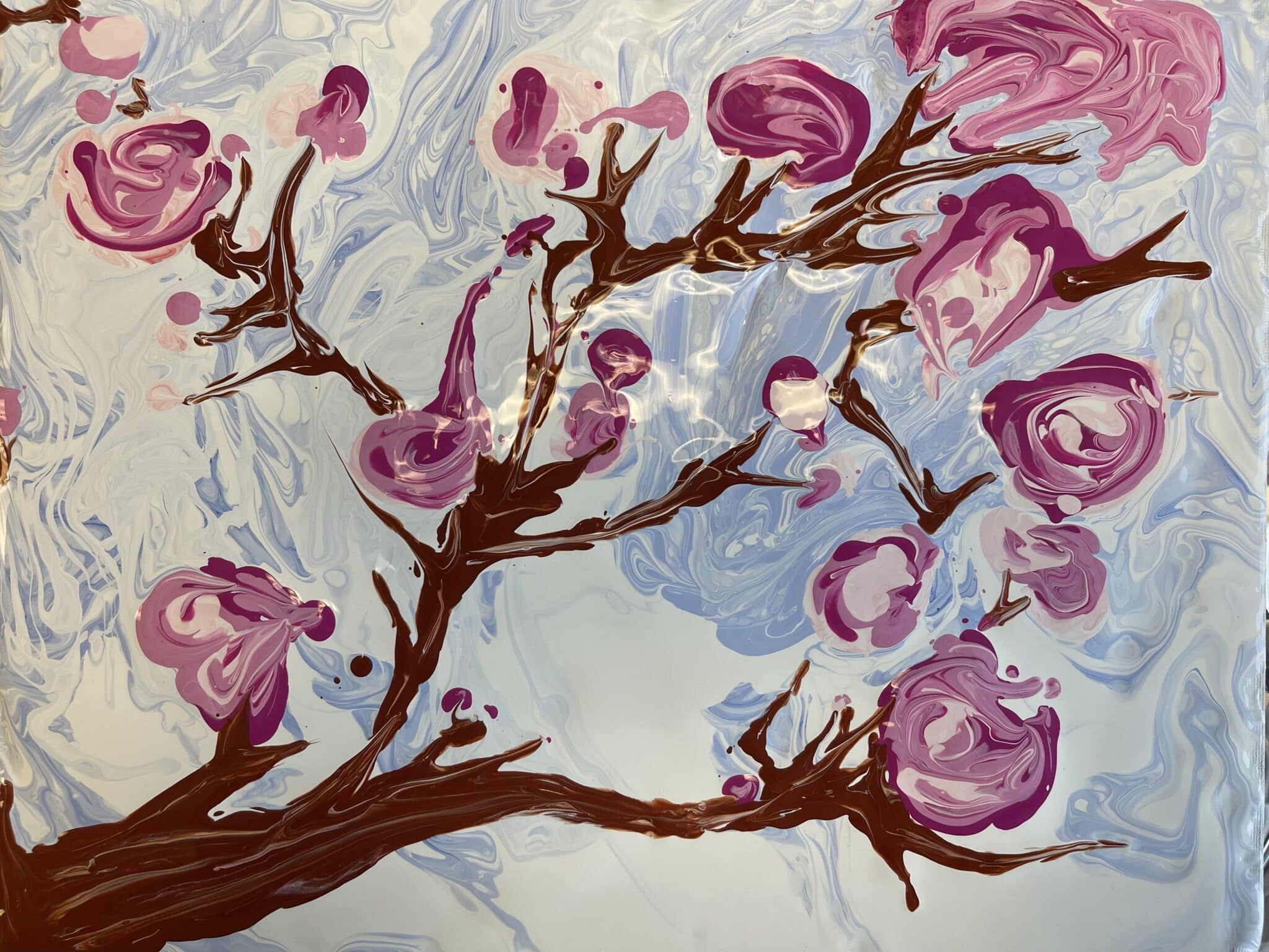 A pour art and acrylic painting of Sakura flowers.